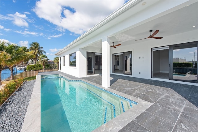 view of swimming pool with ceiling fan and a patio area