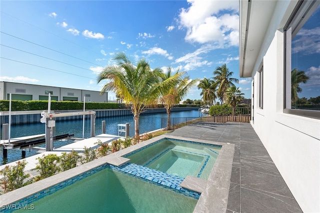 view of pool featuring a water view, an in ground hot tub, and a dock