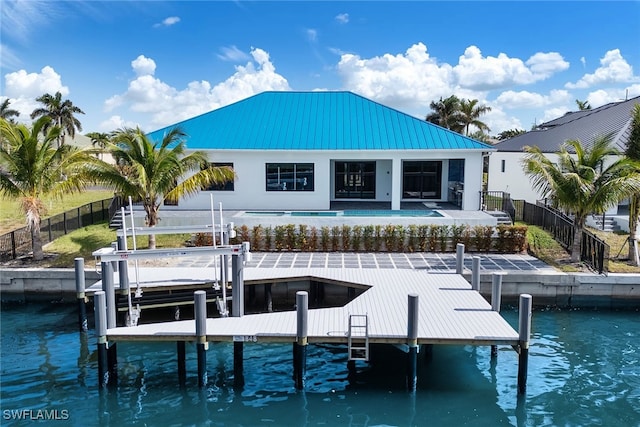 dock area featuring a water view and a patio area