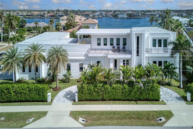 view of front of home featuring a balcony and a water view