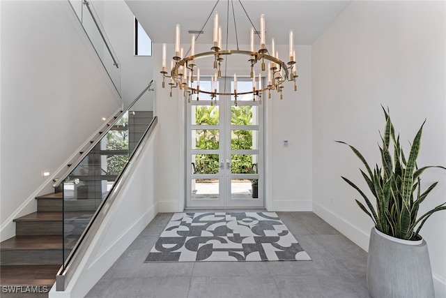 foyer with an inviting chandelier and french doors