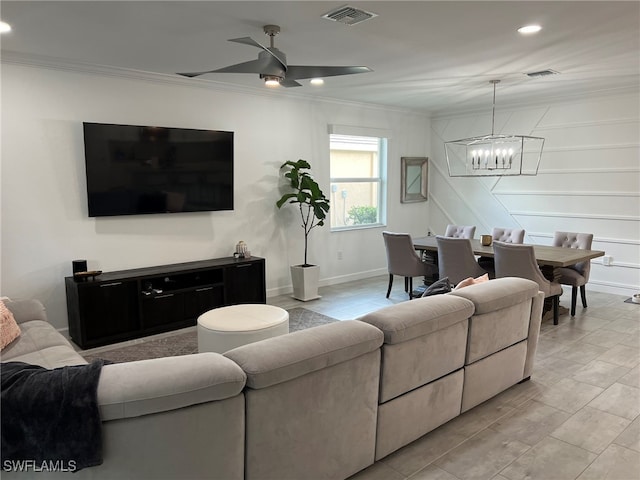 living room with ceiling fan with notable chandelier and ornamental molding