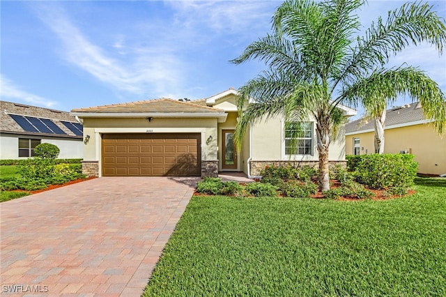 view of front of house with a garage and a front lawn