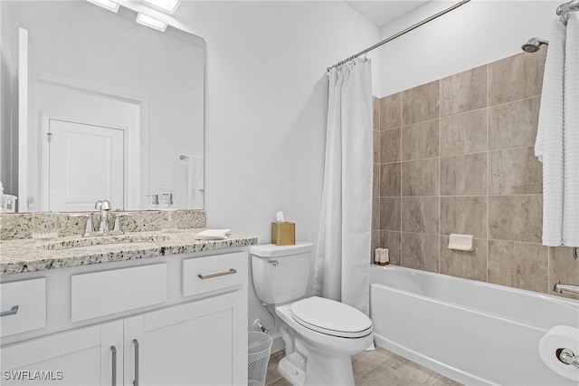 full bathroom featuring shower / bath combo, vanity, and toilet