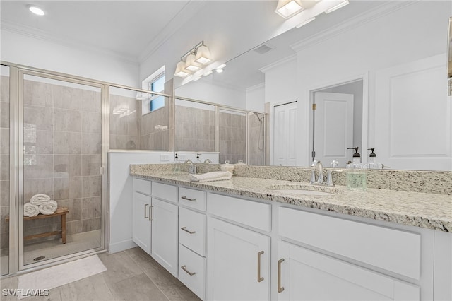 bathroom with an enclosed shower, vanity, and crown molding