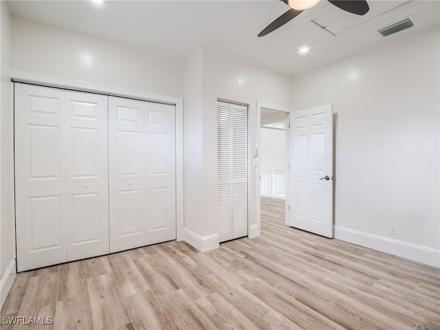 unfurnished bedroom featuring ceiling fan, light wood-type flooring, and a closet