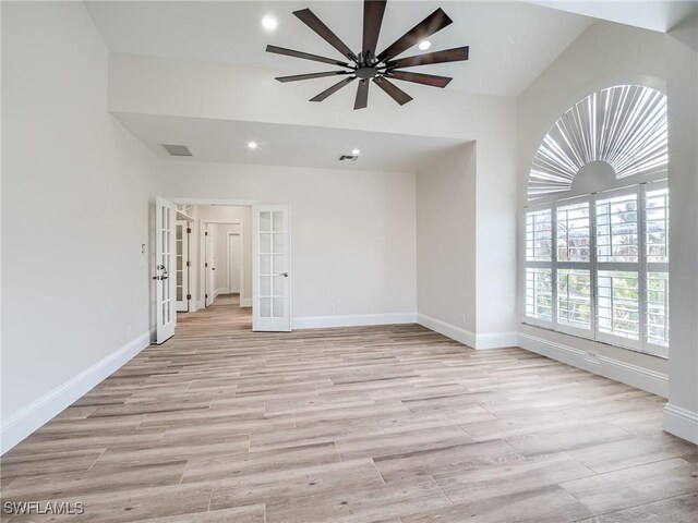 empty room featuring light hardwood / wood-style flooring, french doors, and ceiling fan