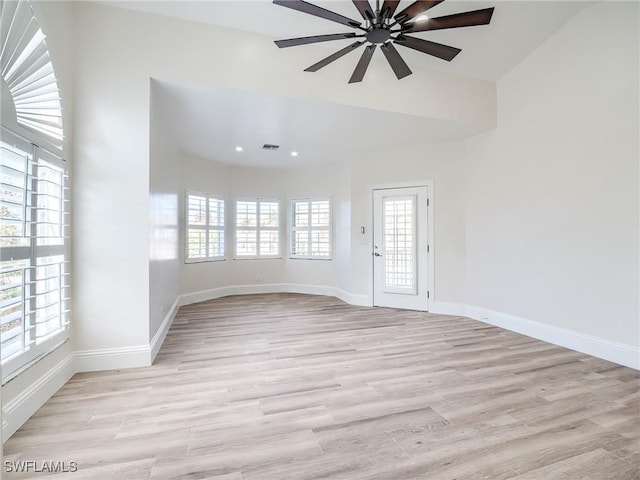 empty room featuring ceiling fan and light hardwood / wood-style floors