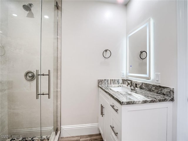 bathroom with vanity and a shower with shower door