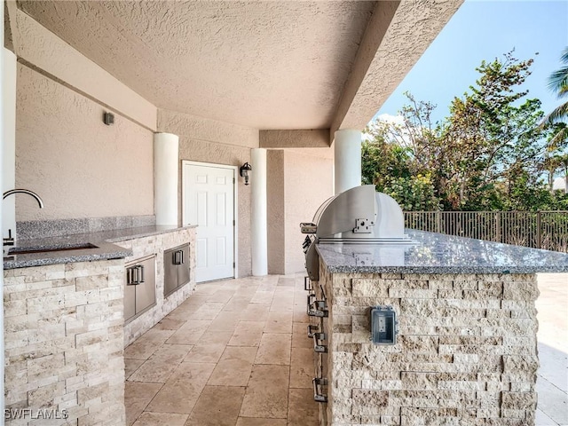 view of patio / terrace with area for grilling and sink