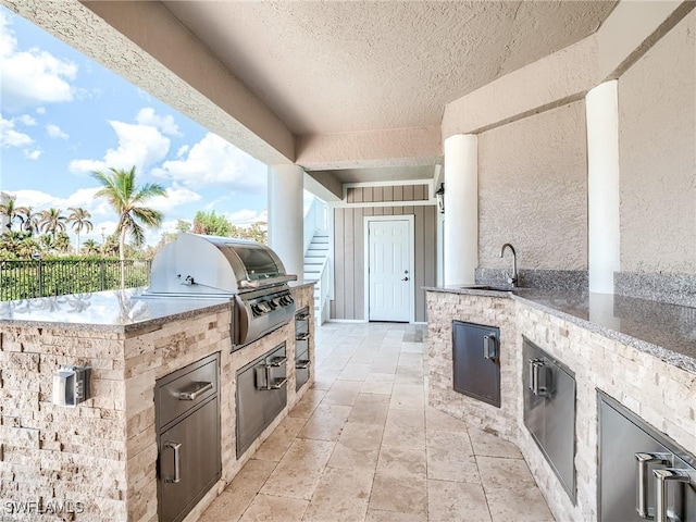 view of patio / terrace with a grill, exterior kitchen, and sink