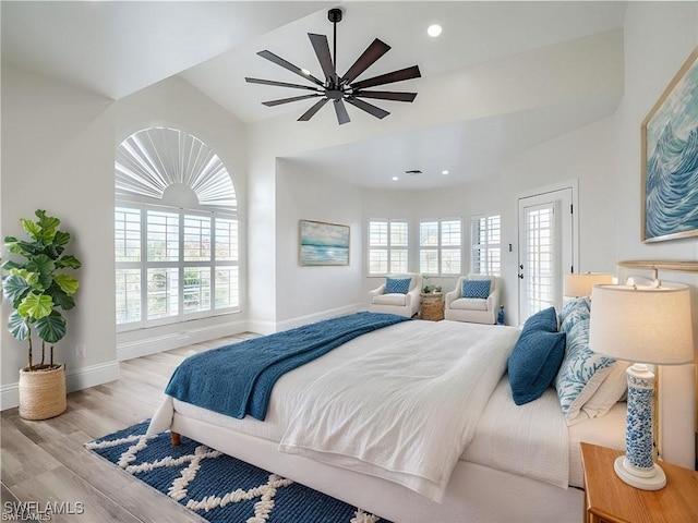 bedroom with ceiling fan, access to exterior, and light wood-type flooring