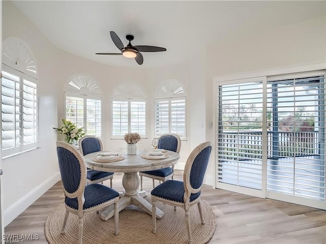 dining space with light hardwood / wood-style floors and ceiling fan