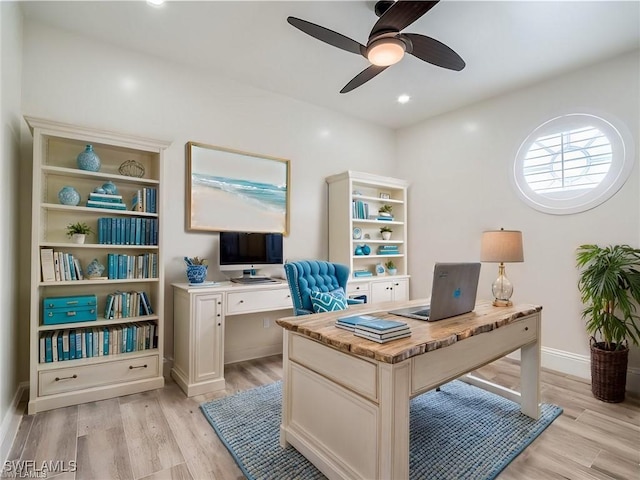 office space featuring ceiling fan and light wood-type flooring