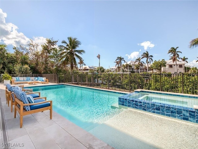 view of swimming pool with an in ground hot tub, outdoor lounge area, and a patio