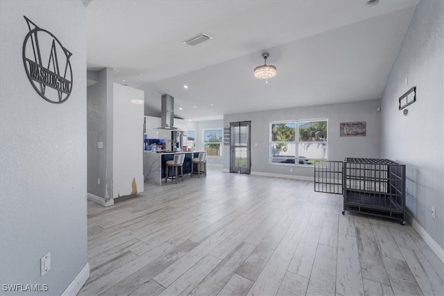 sitting room featuring light hardwood / wood-style floors and lofted ceiling