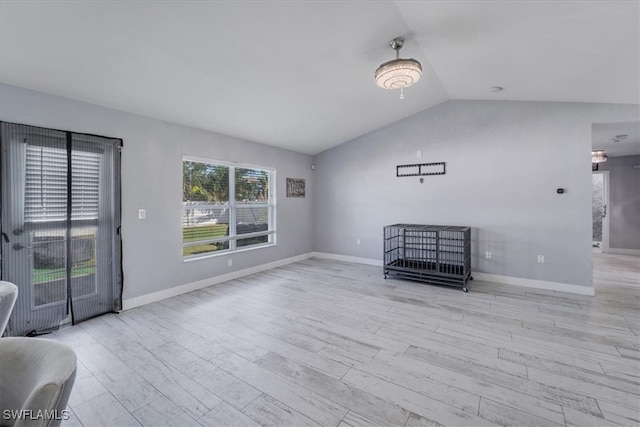 interior space featuring lofted ceiling and light hardwood / wood-style flooring