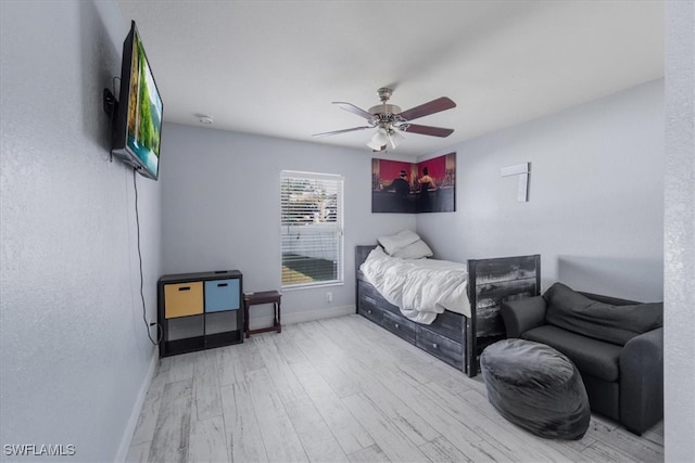 bedroom with light hardwood / wood-style flooring and ceiling fan