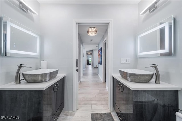 bathroom with vanity and wood-type flooring