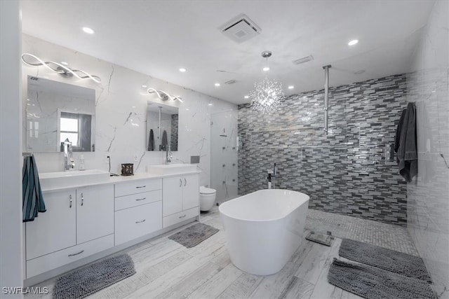 full bathroom with vanity, toilet, tile walls, and independent shower and bath