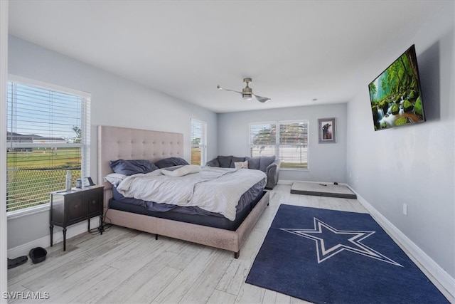 bedroom with wood-type flooring and ceiling fan