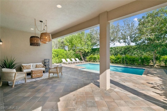 view of pool featuring an outdoor living space and a patio