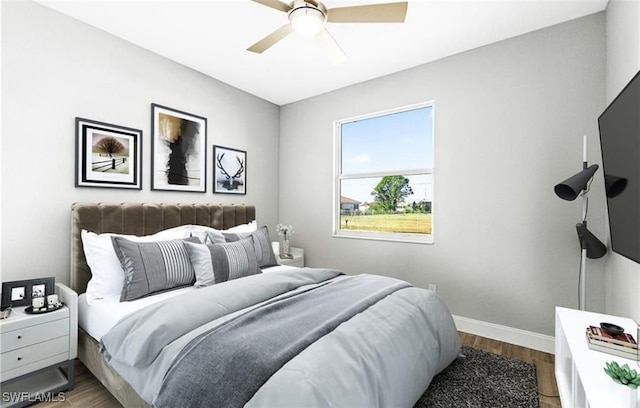 bedroom featuring hardwood / wood-style floors and ceiling fan