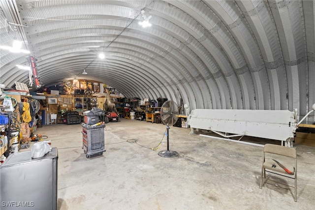 misc room featuring lofted ceiling and concrete floors