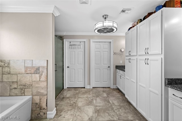 bathroom featuring vanity, ornamental molding, and plus walk in shower