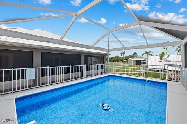 view of swimming pool with a lanai