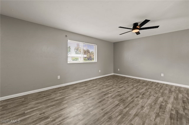 spare room with hardwood / wood-style floors and ceiling fan