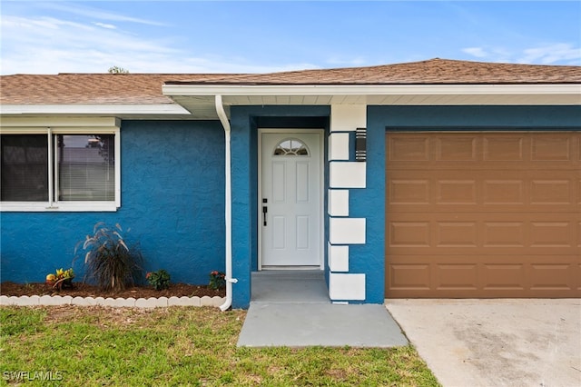 doorway to property featuring a garage