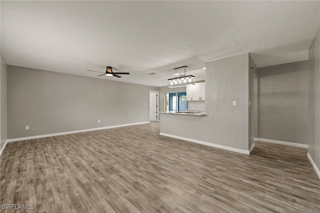 unfurnished living room with light hardwood / wood-style floors and ceiling fan