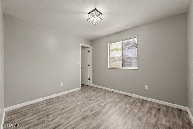 spare room with light wood-type flooring