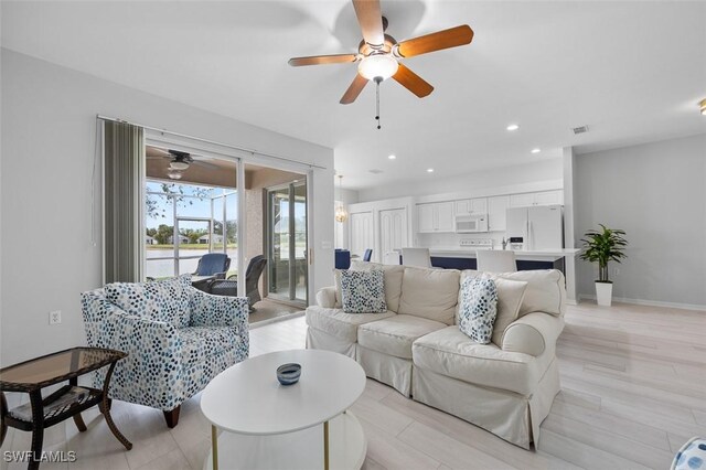 21566 Portrush Run, Estero, FL 33928 - living room featuring a ceiling fan, recessed lighting, baseboards, and light wood-style flooring