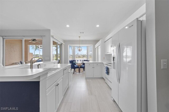 21566 Portrush Run, Estero, FL 33928 - kitchen featuring white appliances, plenty of natural light, recessed lighting, a ceiling fan, and a sink