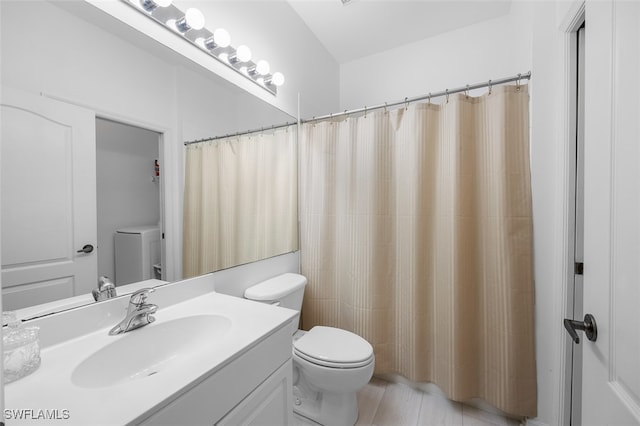 bathroom featuring vanity, curtained shower, toilet, and washer / dryer