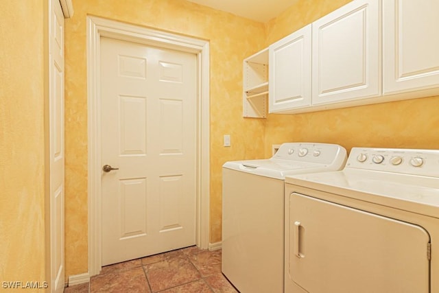 clothes washing area featuring cabinets, independent washer and dryer, and light tile patterned flooring