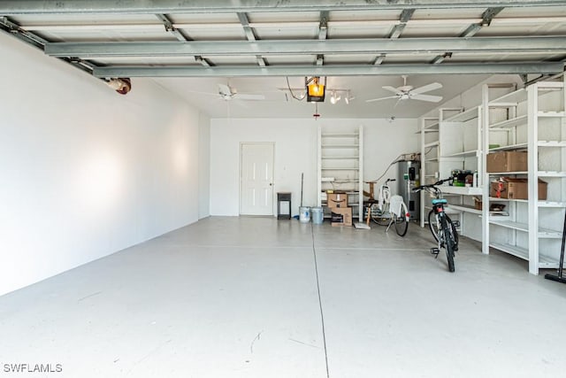 garage featuring ceiling fan, a garage door opener, and water heater