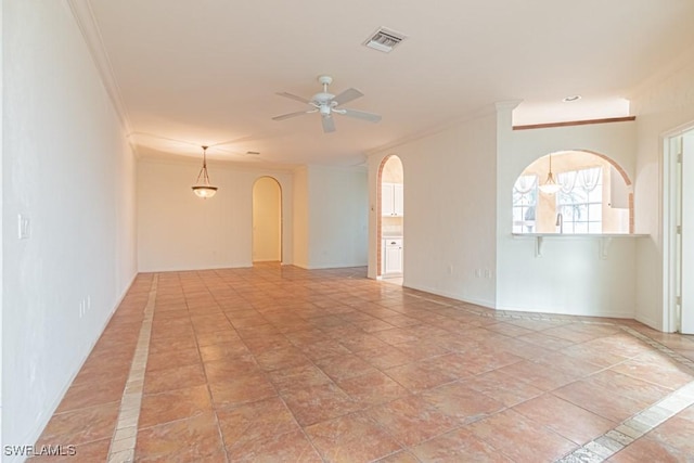 unfurnished room with ceiling fan, light tile patterned flooring, and ornamental molding