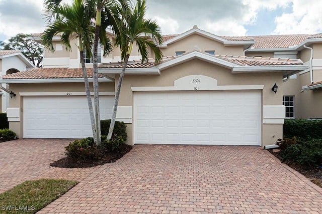 mediterranean / spanish-style home with a garage