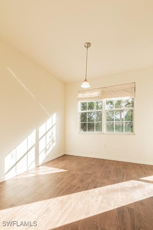 unfurnished room with hardwood / wood-style flooring