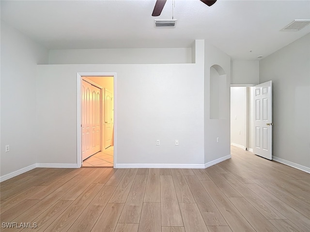 spare room featuring light wood-type flooring and ceiling fan