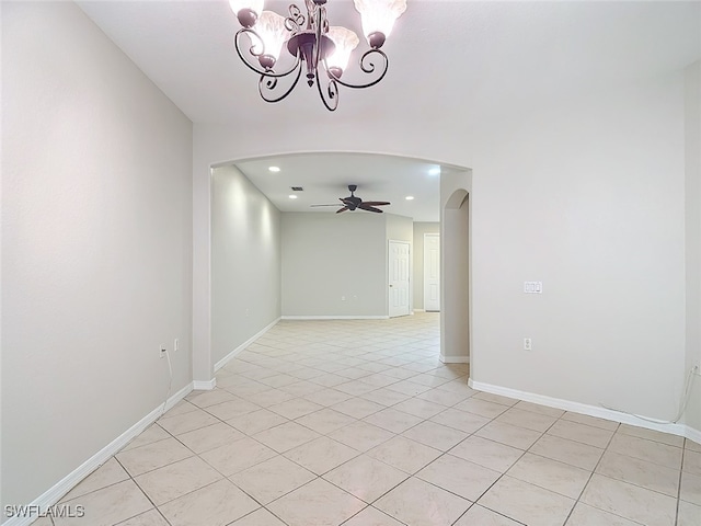 empty room featuring light tile patterned floors and ceiling fan with notable chandelier