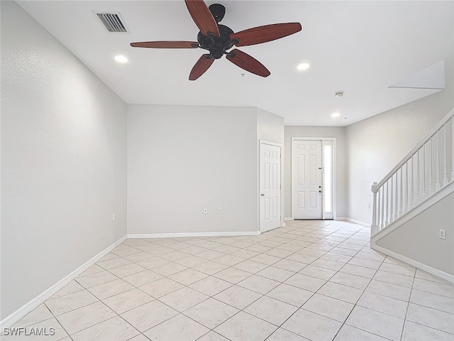 empty room featuring light tile patterned floors and ceiling fan