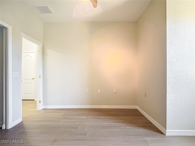 spare room with light hardwood / wood-style floors and ceiling fan