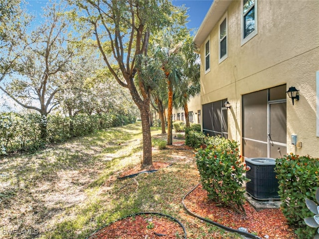 view of yard with central air condition unit