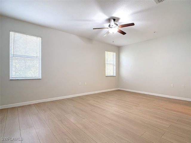 unfurnished room featuring ceiling fan, a textured ceiling, and light wood-type flooring