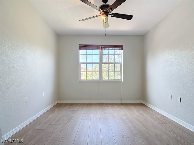 spare room featuring ceiling fan and light wood-type flooring