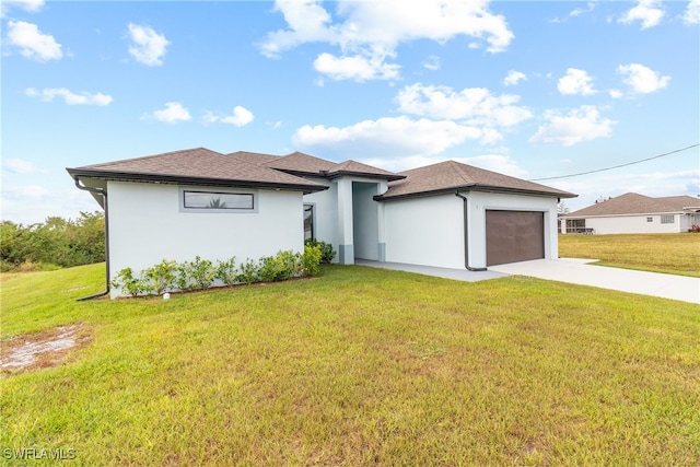 view of front of home featuring a garage and a front lawn